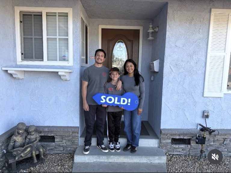 happy family smiling on the doorstep of their ventura home that Jess Judd helped them purchase